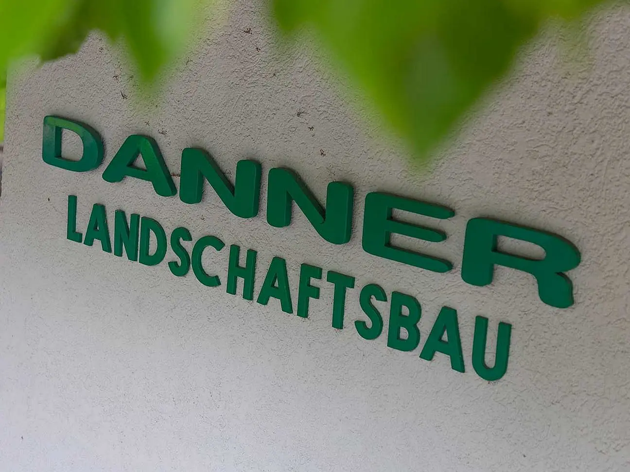 © Danner Landschaftsbau/Weickinger Firmenwortlaut Danner Landschaftsbau in Grün.